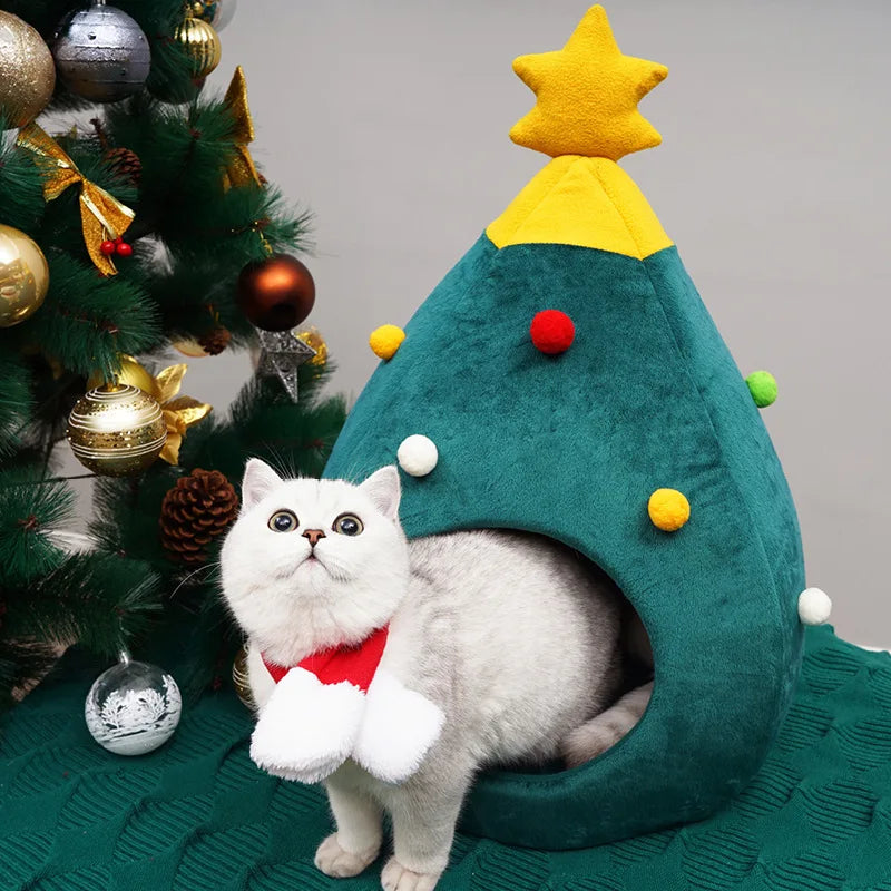 Gato descansando dentro de la cama cueva de árbol de Navidad