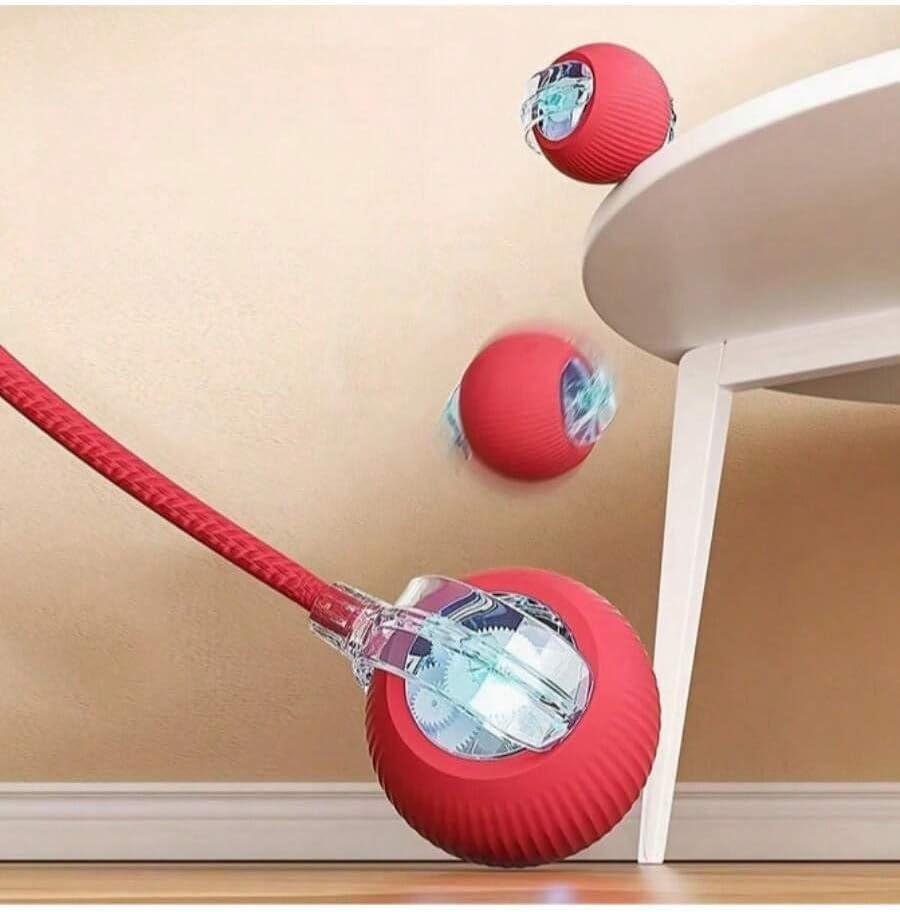 Pelota automática roja saliendo de debajo de una mesa
